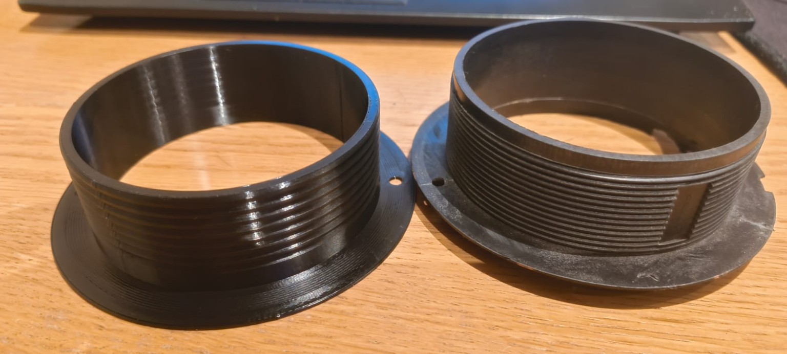 Custom cylindrical fittings with threaded walls and mounting flanges.